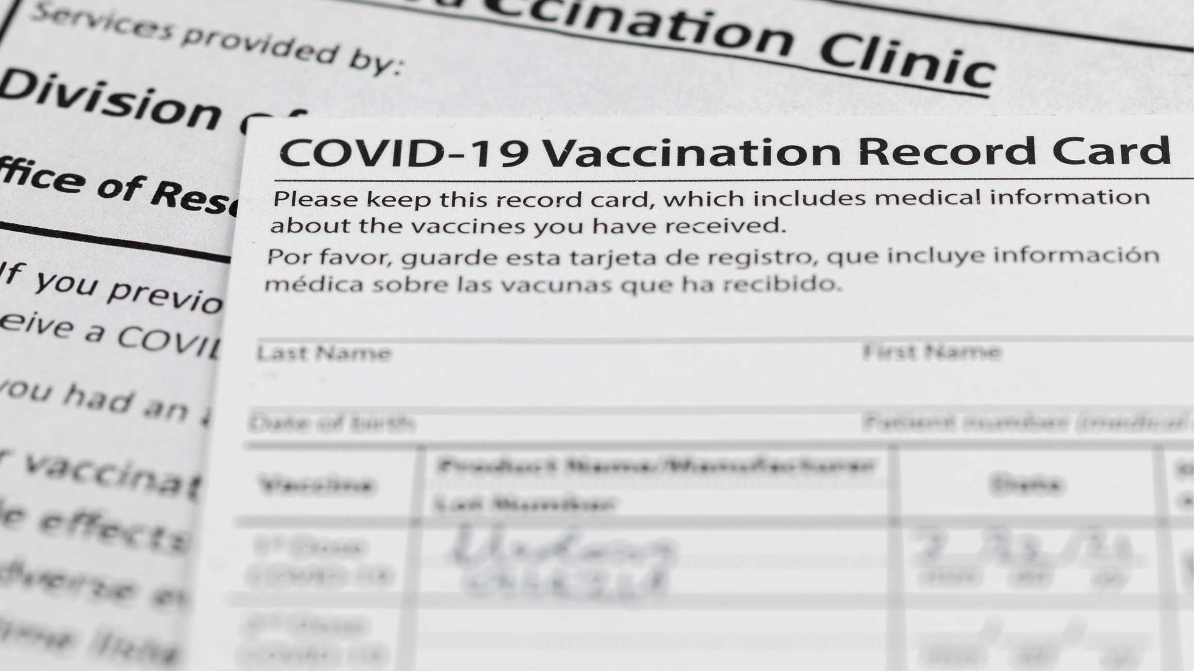 An immunization card for COVID-19 vaccine is shown