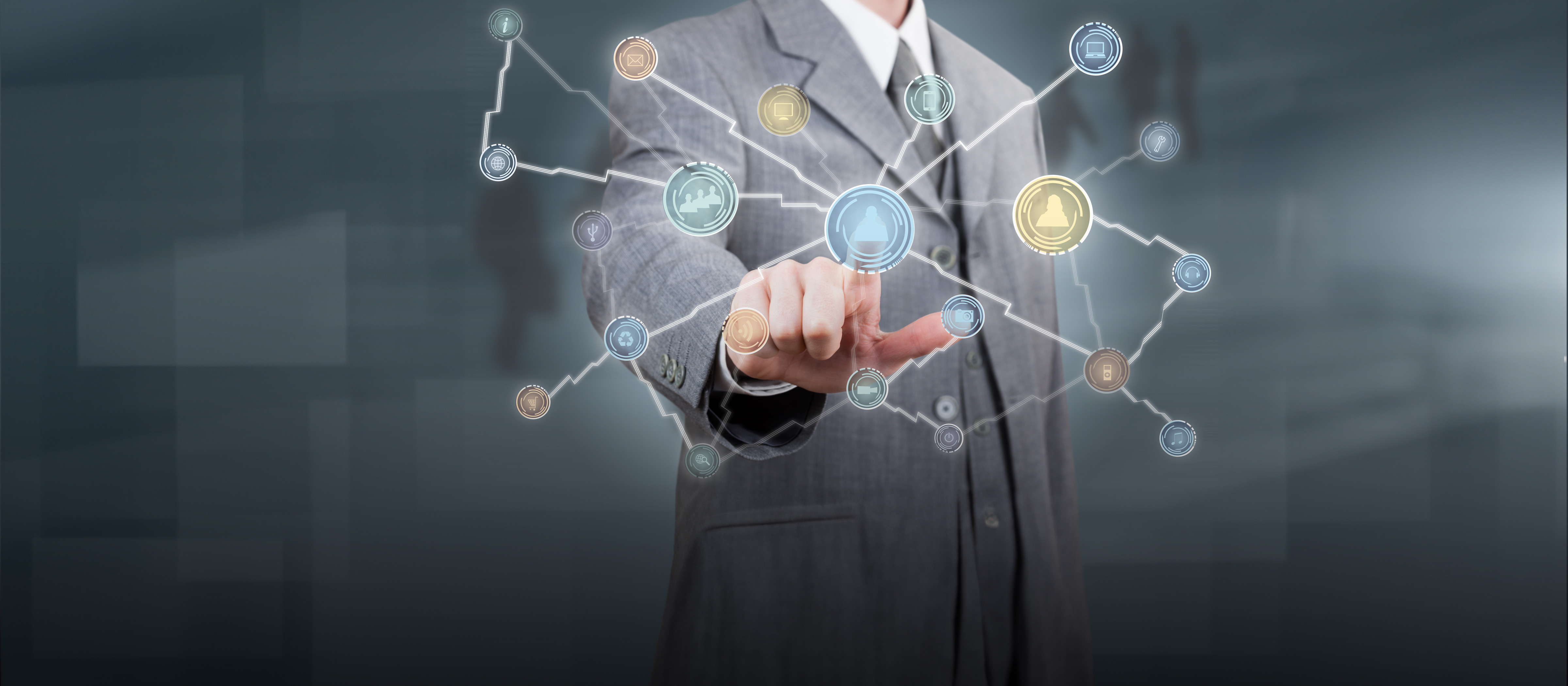 A man in a suit is pointing at a network of icons