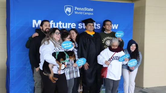 a graduate and his family post for a group photo