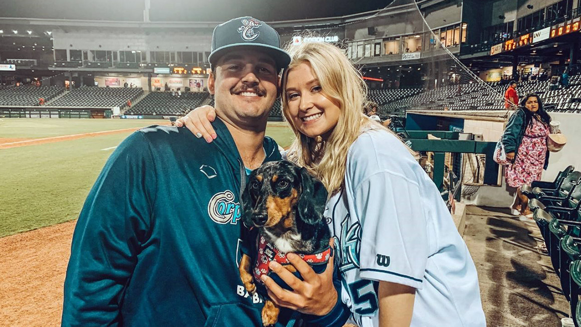 Kylie Smith is shown with her fiance at a baseball stadium.