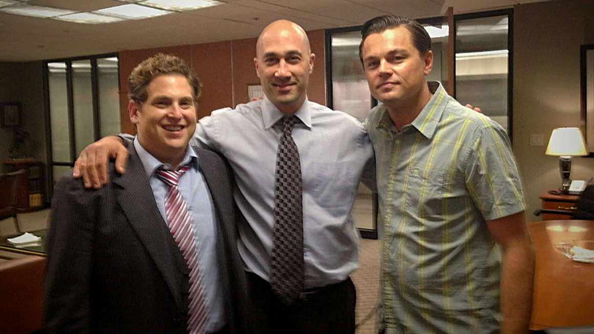 Lawrence Smith poses for a photo with actors Jonah Hill and Leonardo DiCaprio