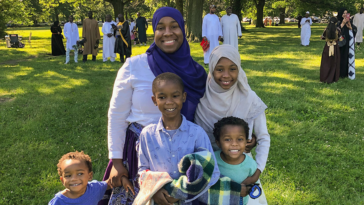 Rachel Azzaam is pictured with her four children in a park.