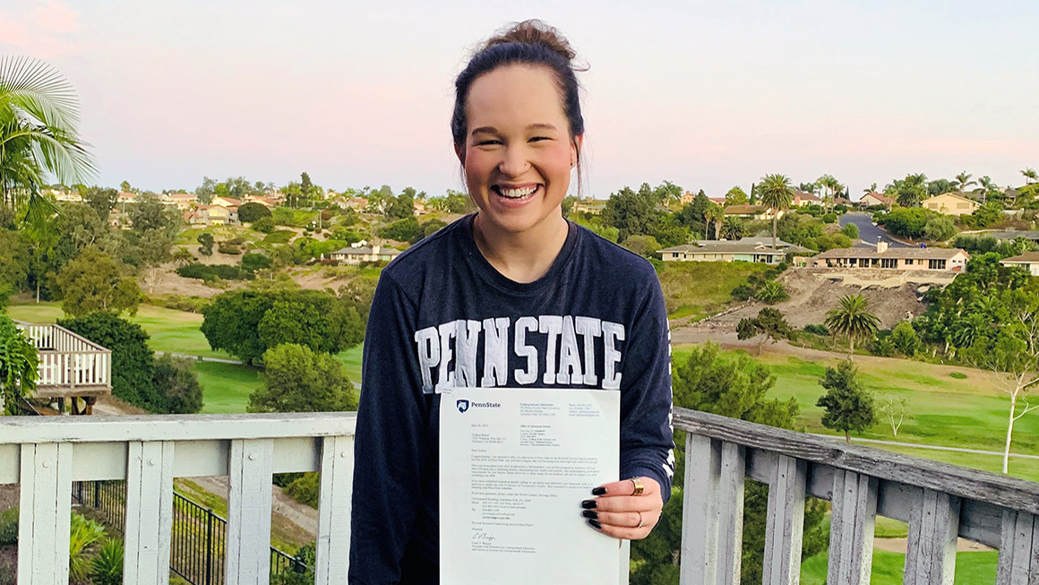 Student stands on her balcony