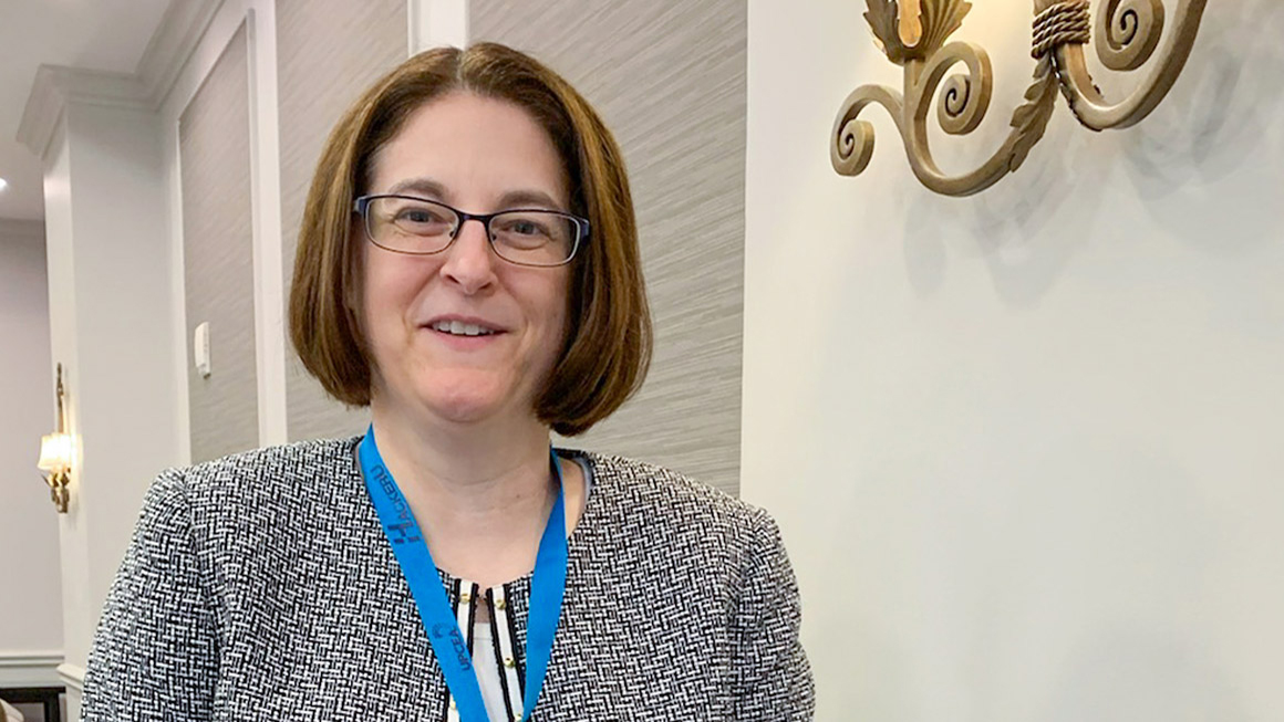 This is a photograph of Penny Ralston-Berg outside a conference room.