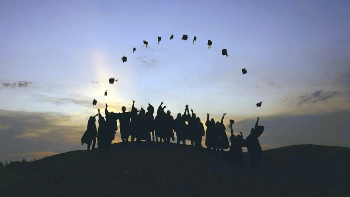 Students throwing grad caps