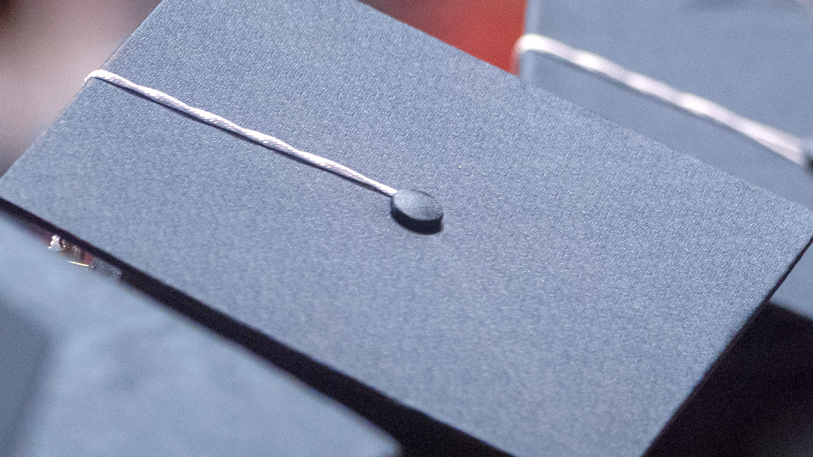 A close-up of a Penn State blue graduation cap and tassel