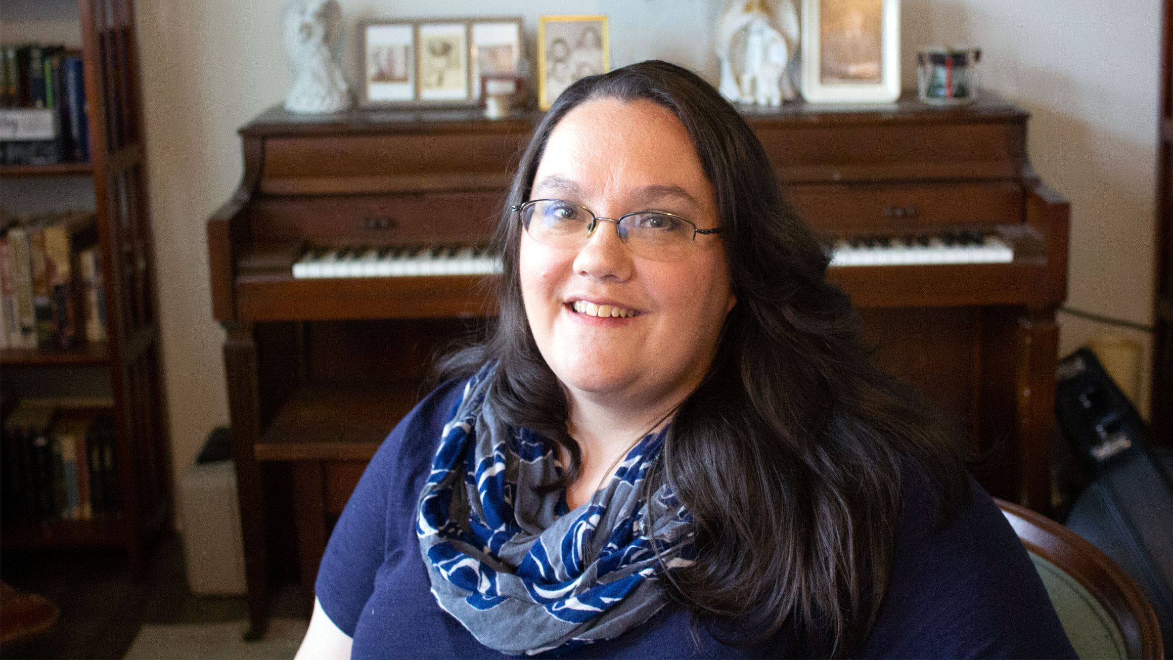 A portrait of Stephanie Files with a piano in the background