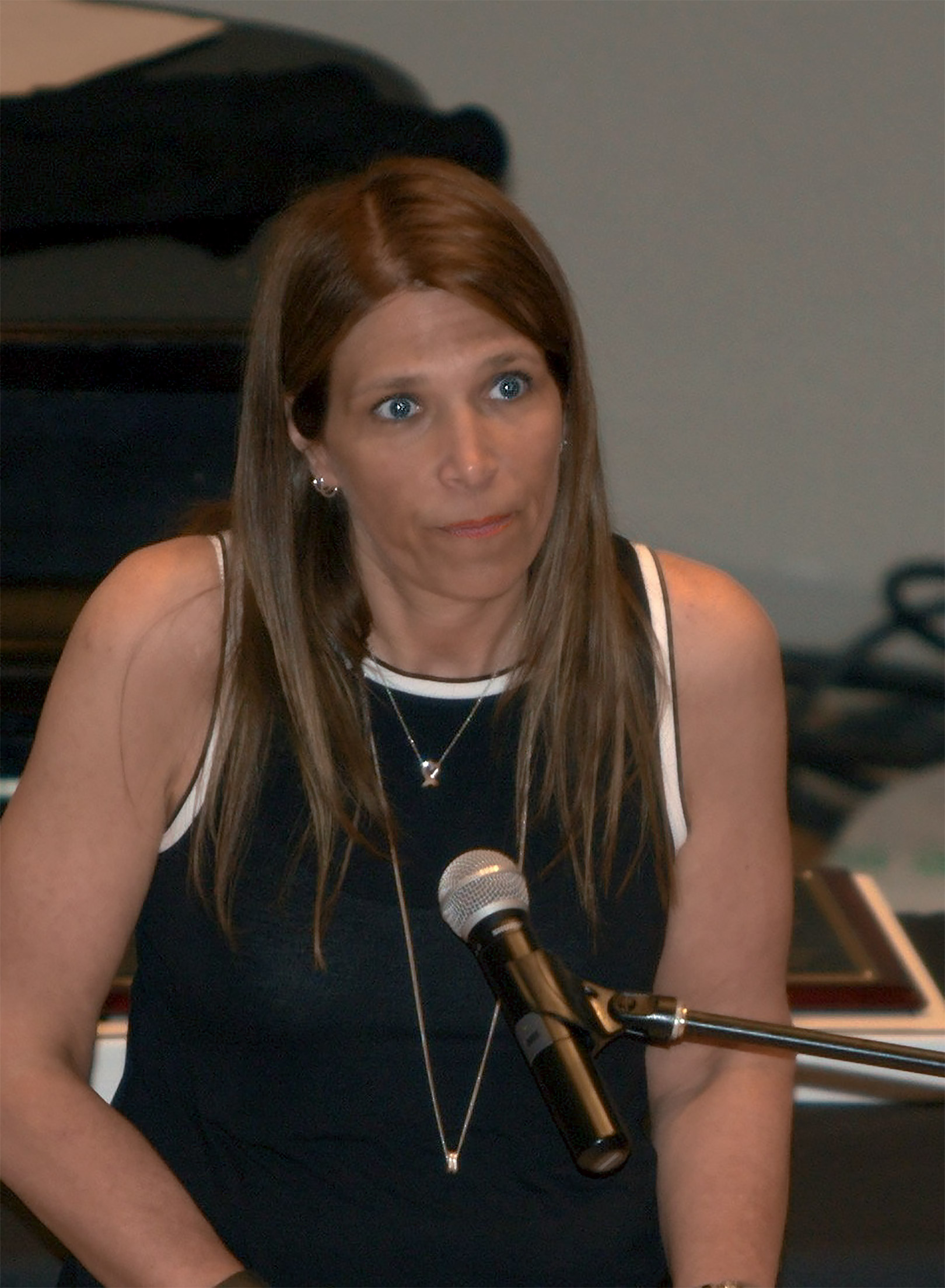 Luci Labriola-Cuffe, a recent Penn State World Campus graduate, speaks into a microphone.