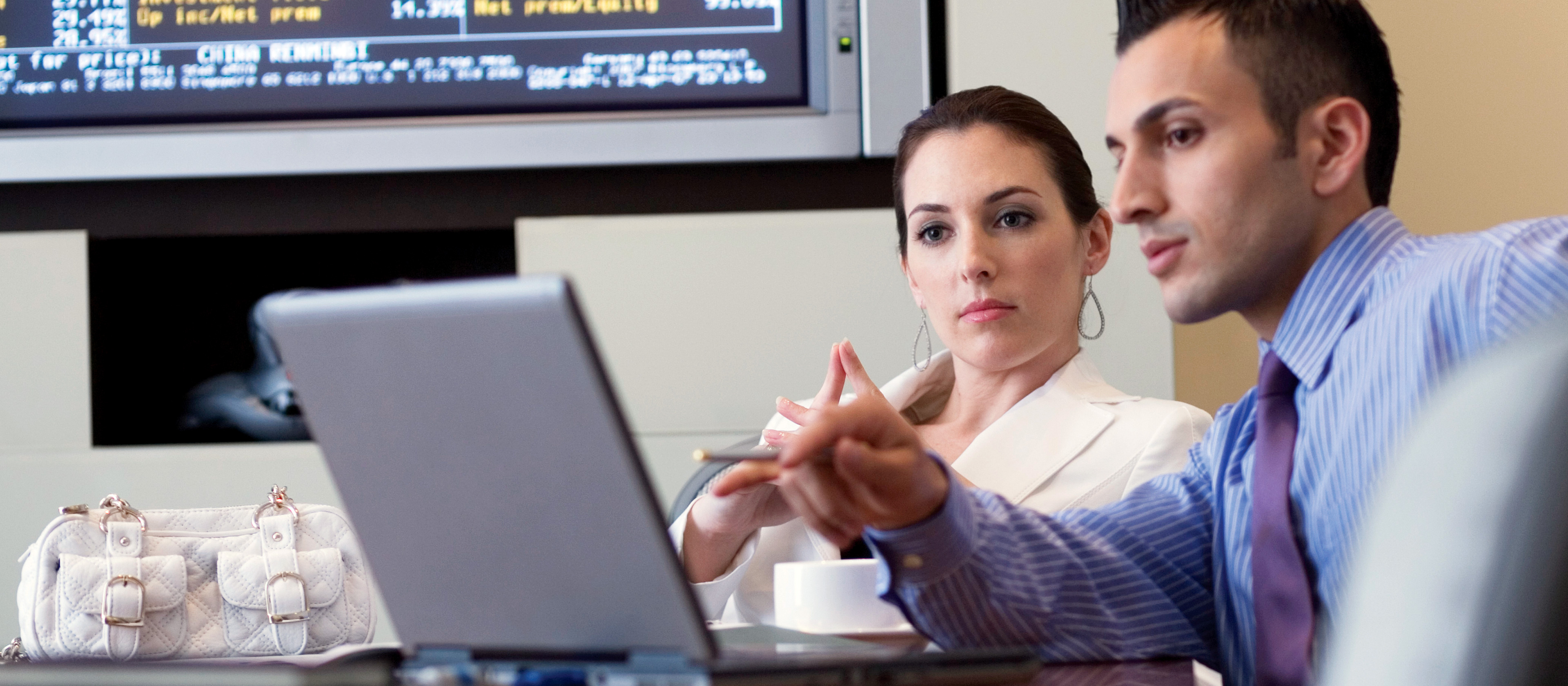 Two business professionals looking at a computer