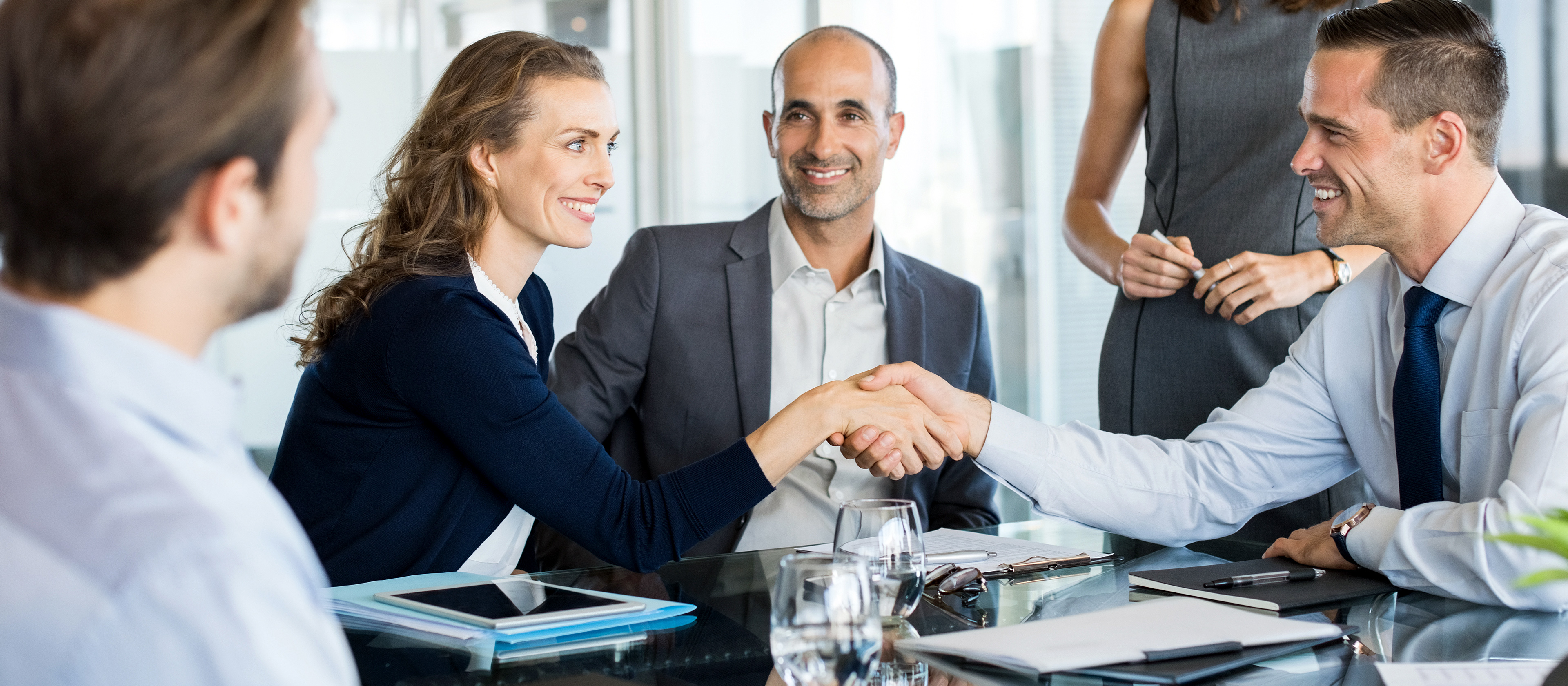 Business professionals shaking hands at a meeting