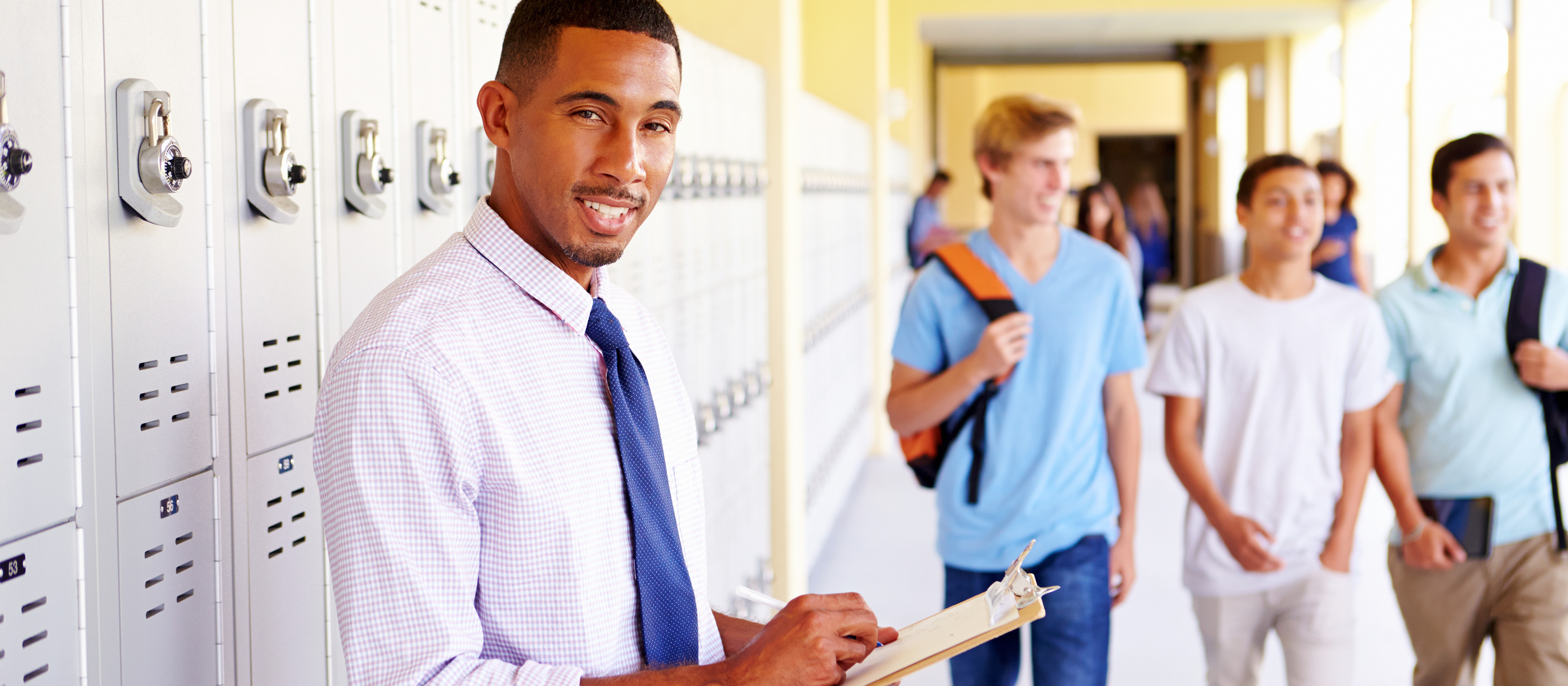 Teacher standing near lockers