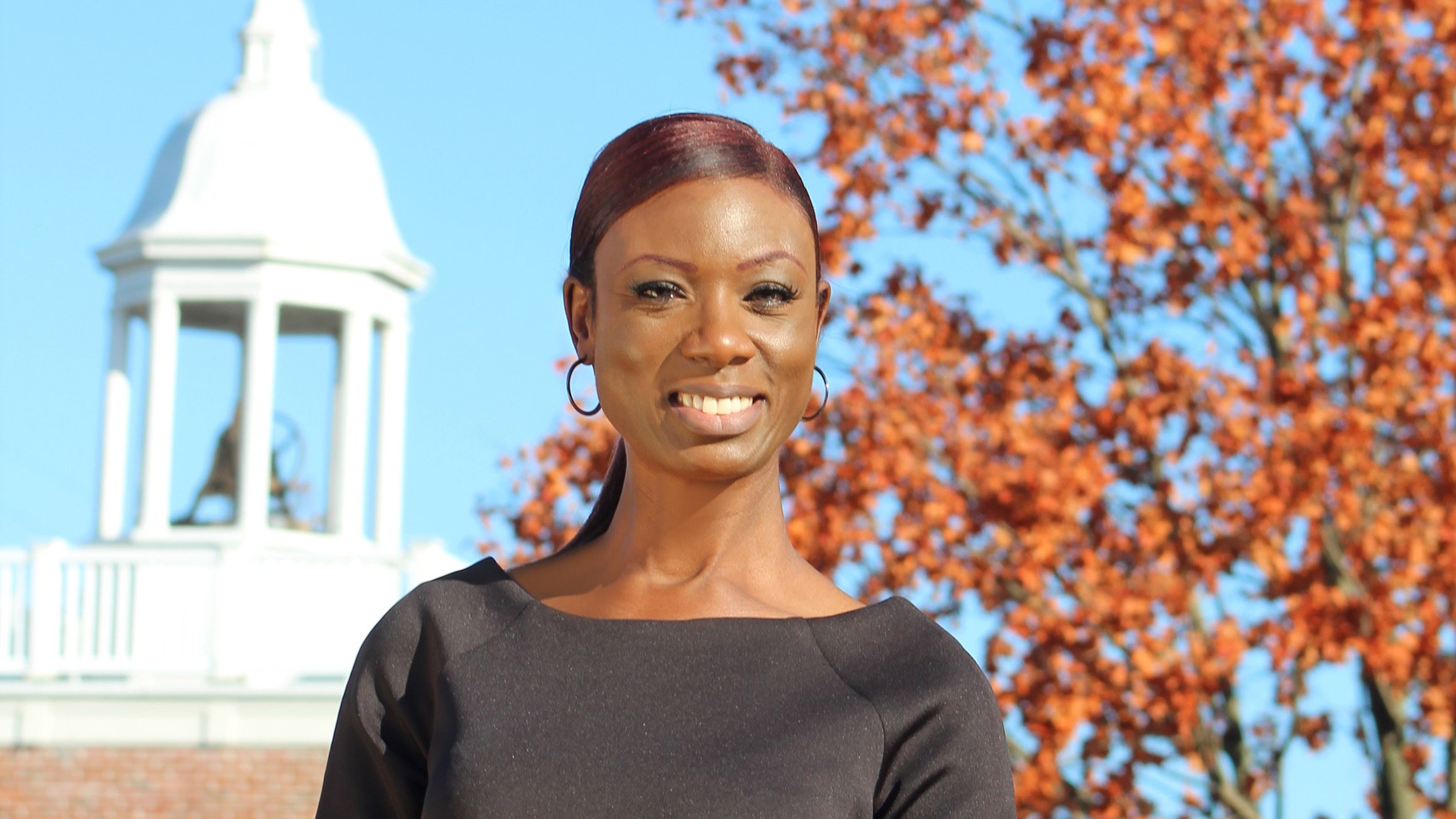 Denita Wright Watson is seen with an historic building in the background.