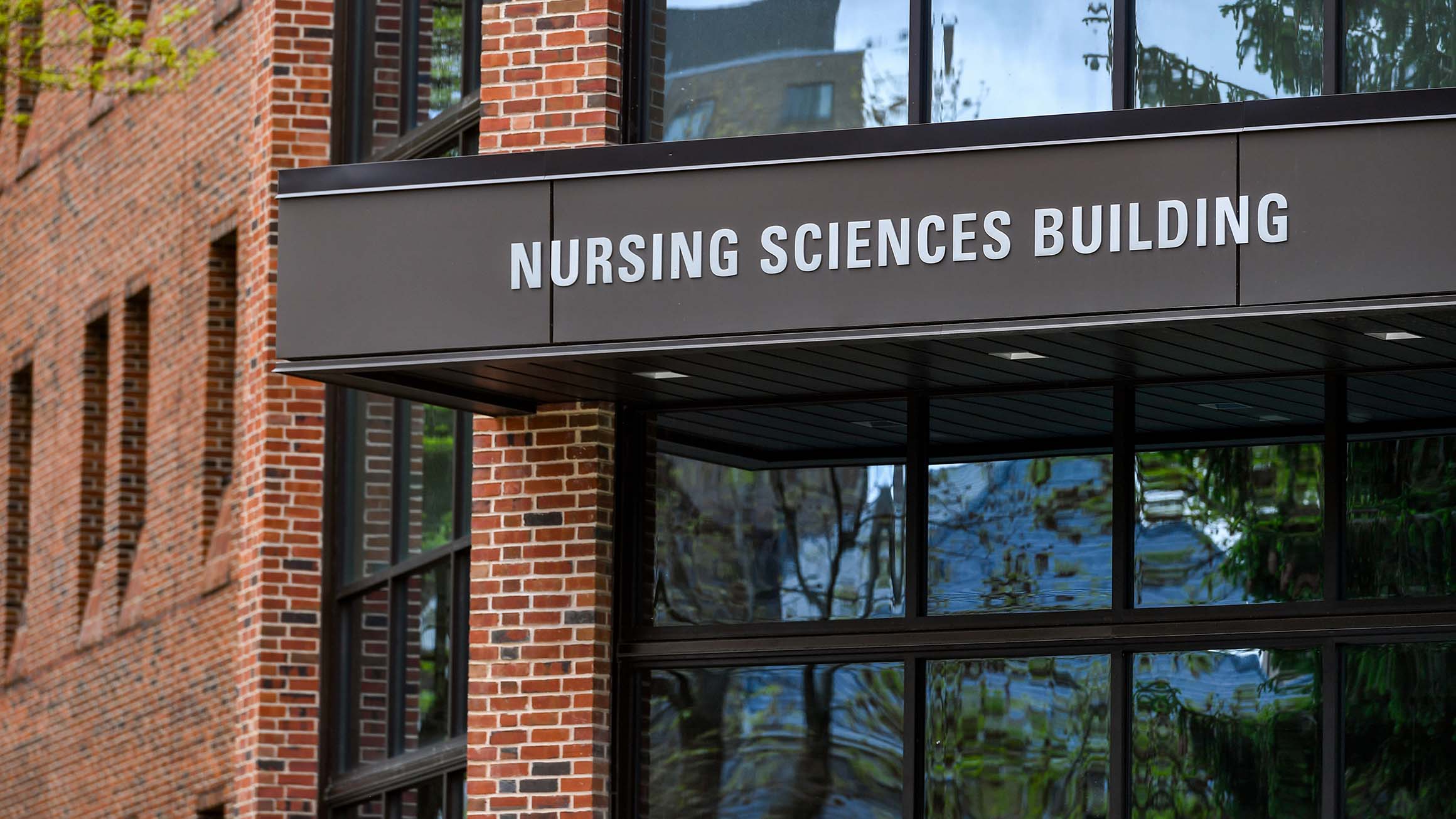 The words of the Nursing Sciences Building are shown on an awning hanging over the entrance.