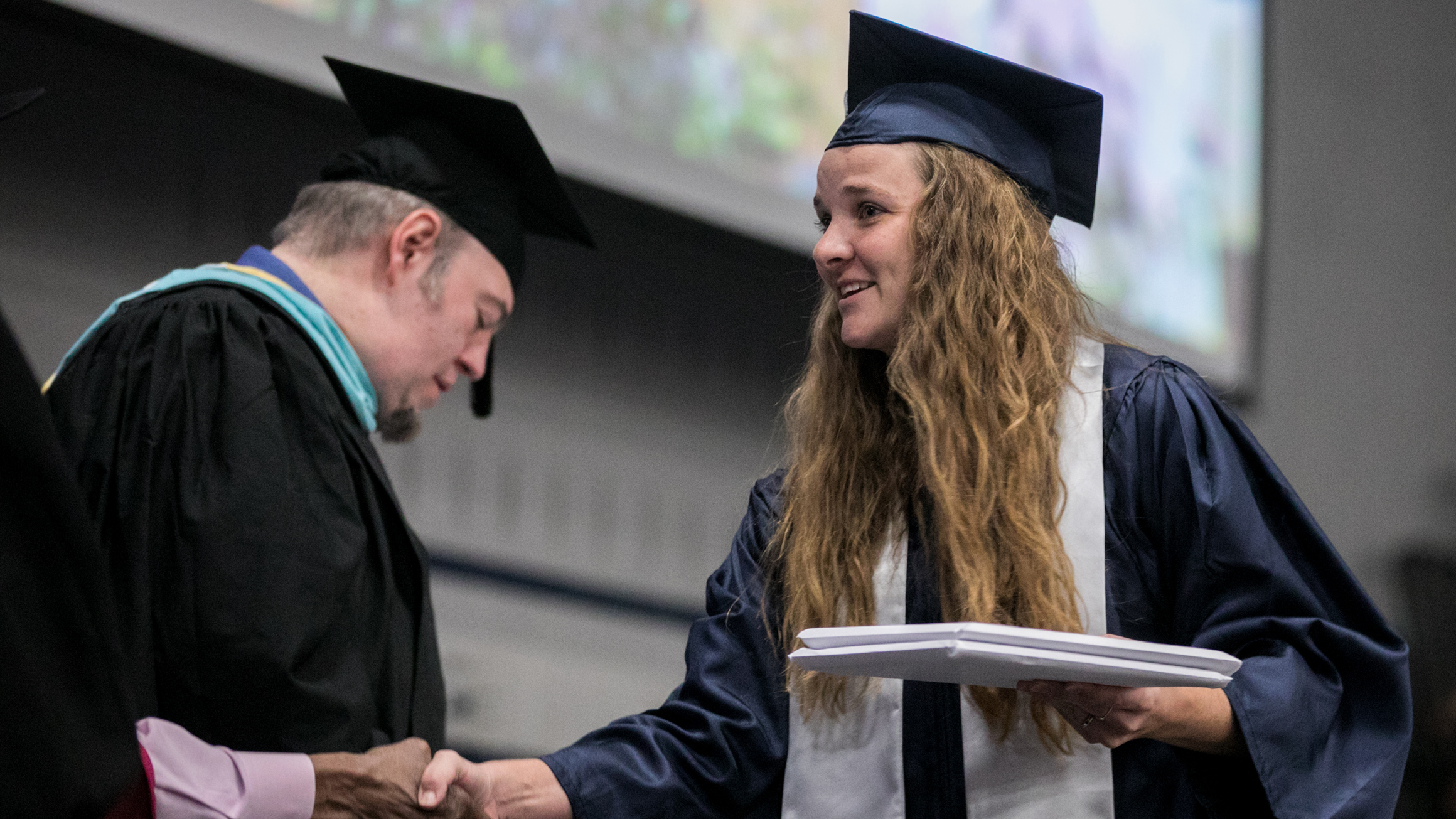 Military student receiving diploma at graduation