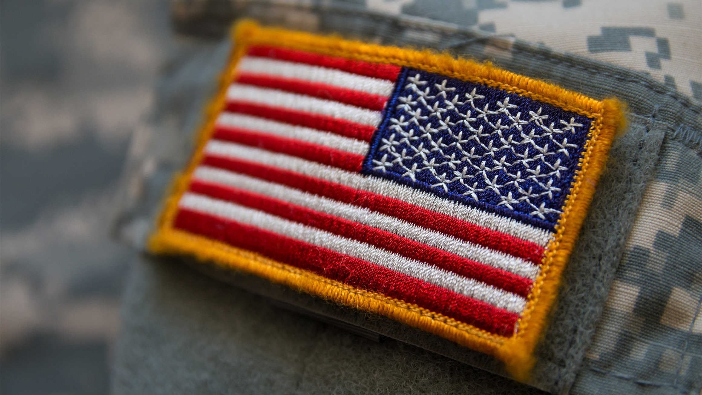 An American flag is seen on army fatigues.