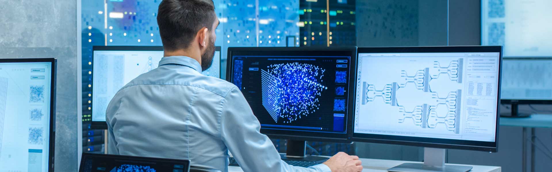 Man working on computer with multiple displays