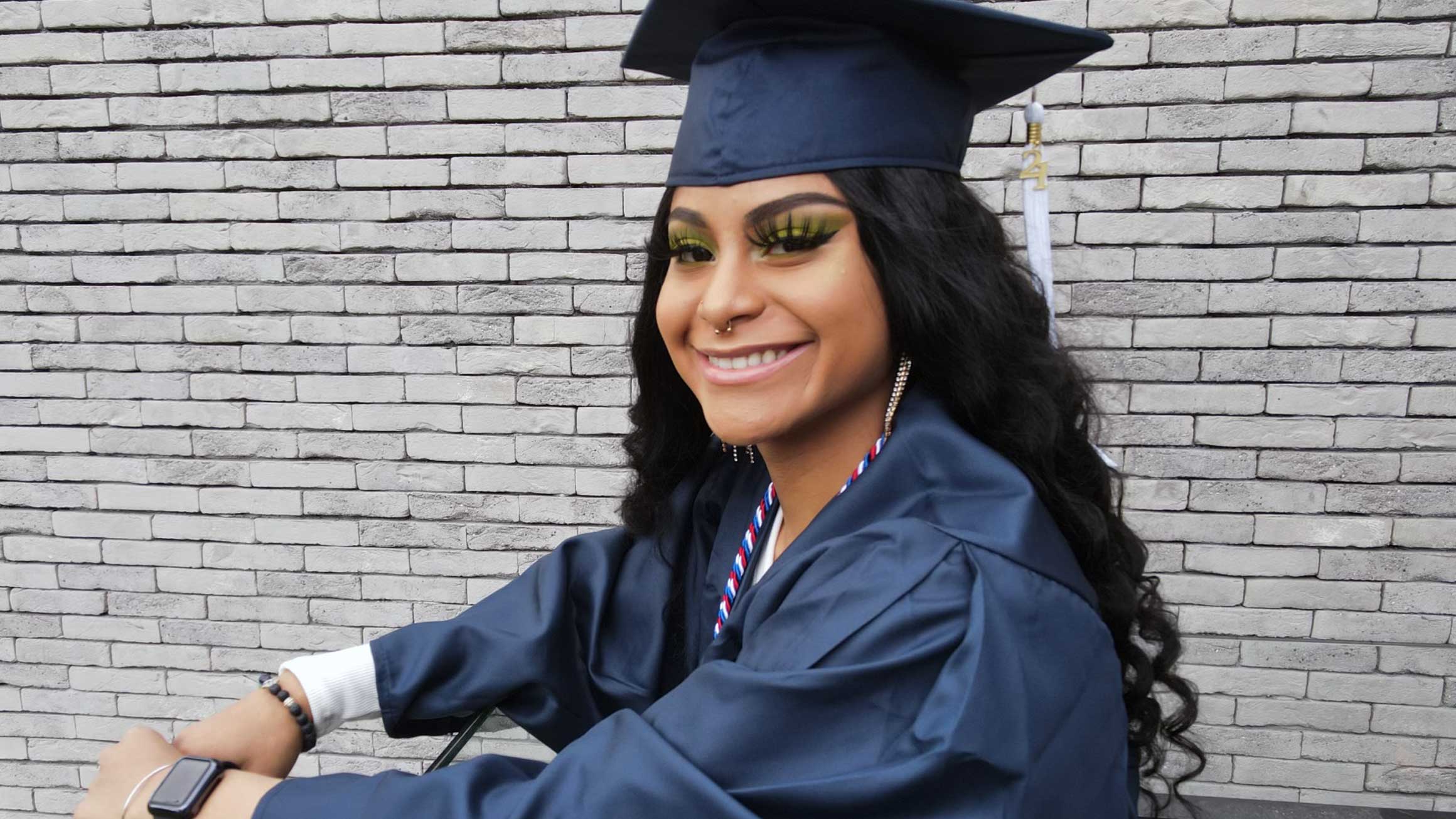 Yanelis Funez smiling in her cap and gown.