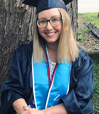 Jona Hall is seeing wearing a graduation cap and gown