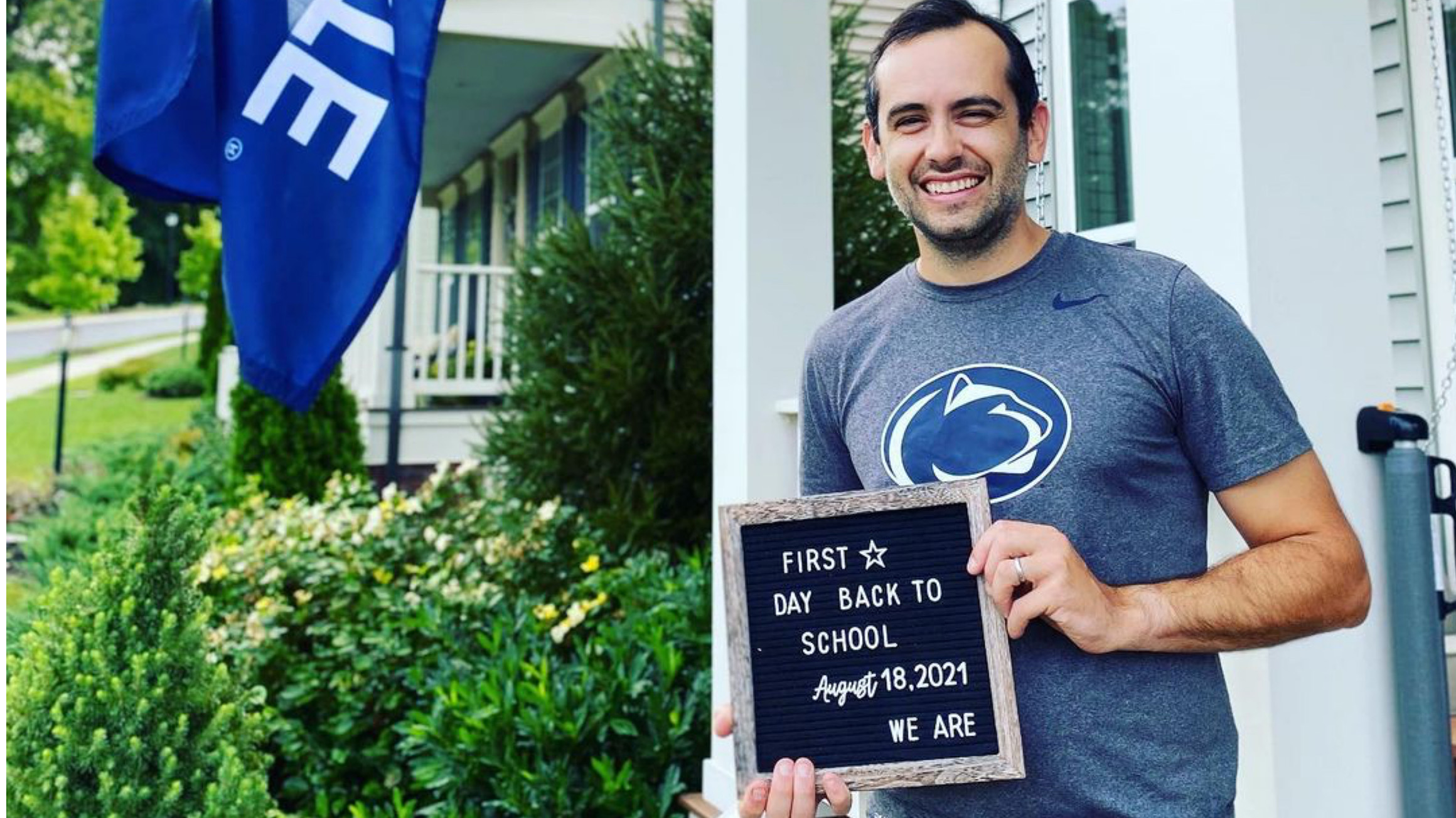 Online MBA student Geoff Calver holds up a letterboard that says August 18 was his first day of school of his residency program.