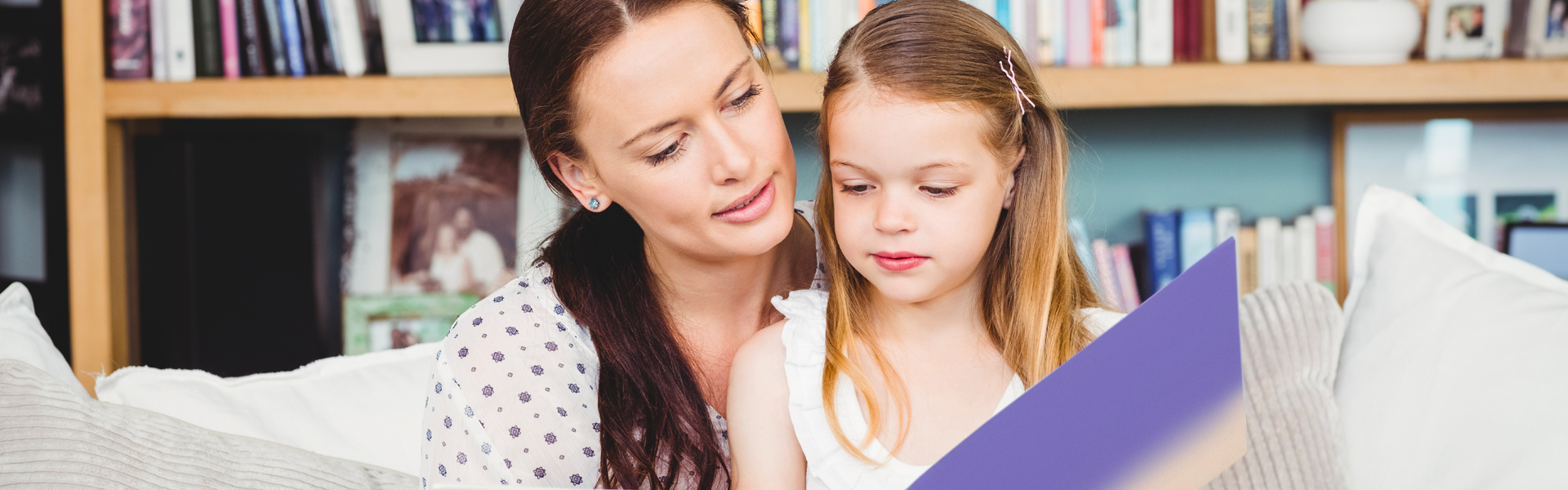 Mother and daughter reading together at home