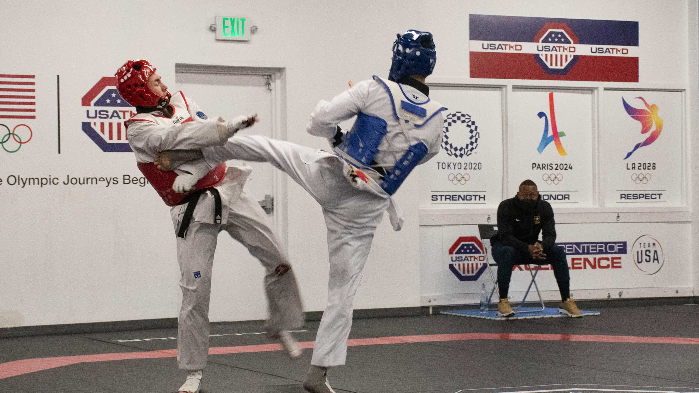 Joshua Liu spars with another person in a gym.