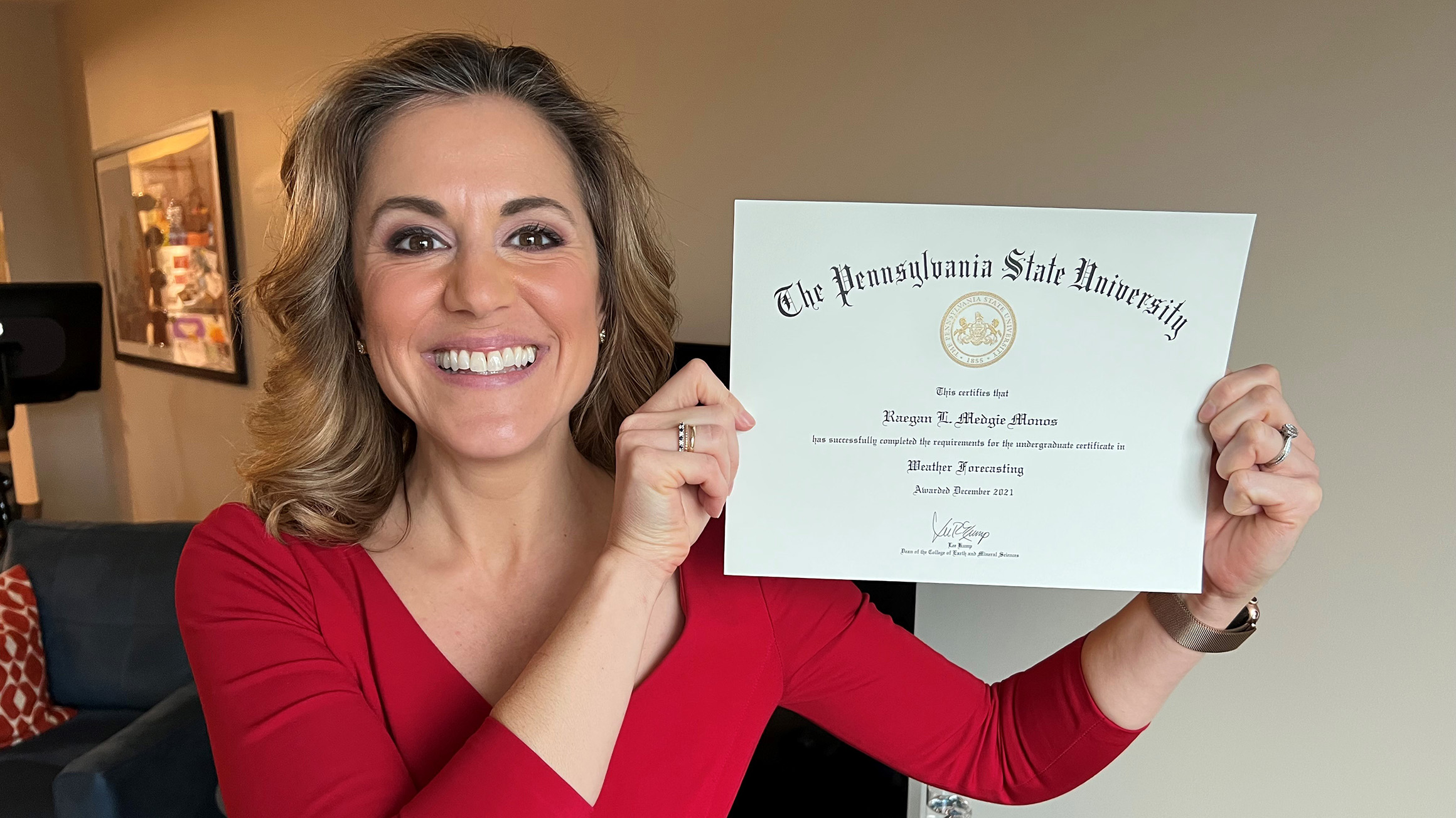 Raegan Medgie holds her Penn State certificate.