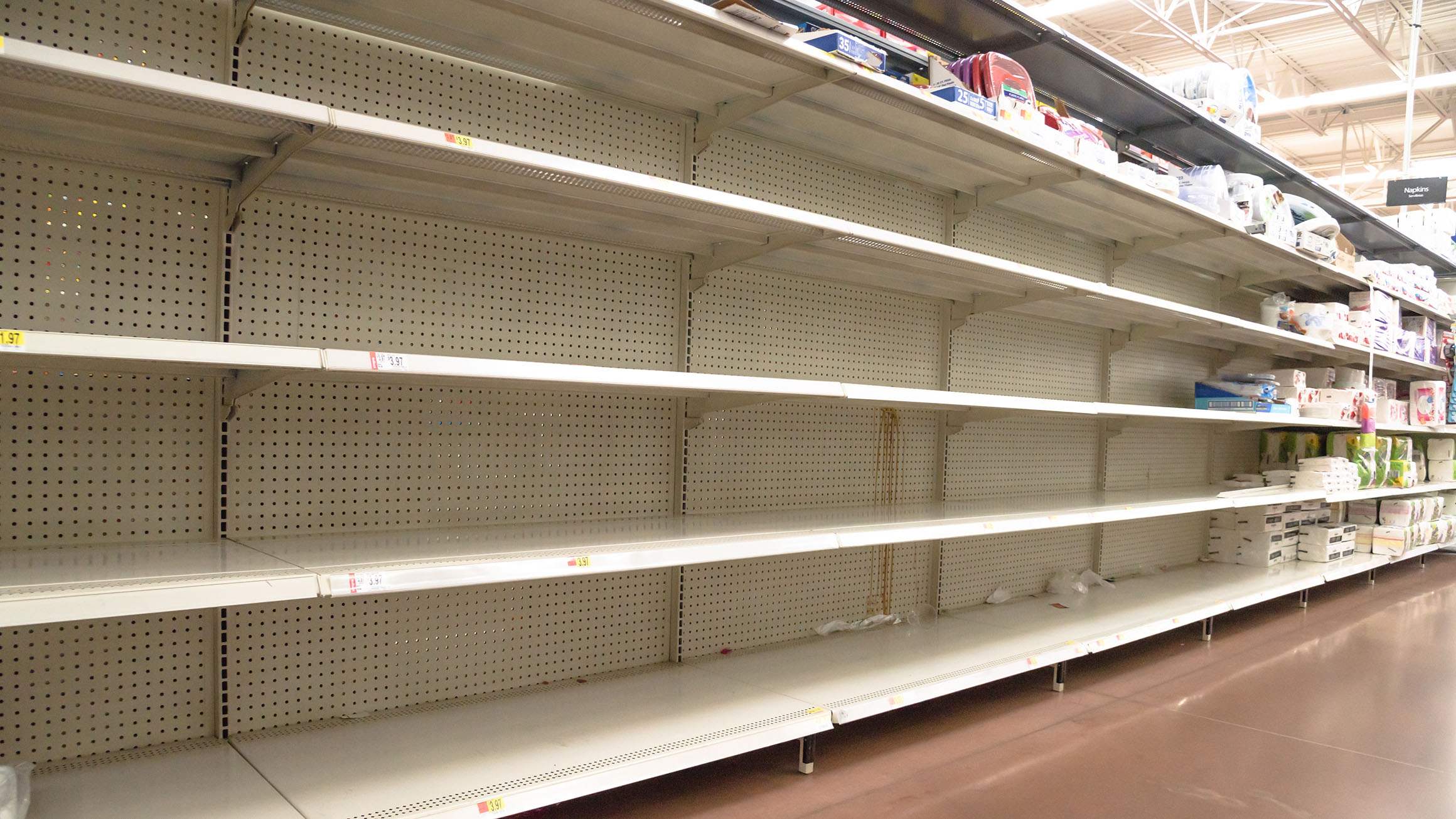Empty shelves at a grocery store are shown