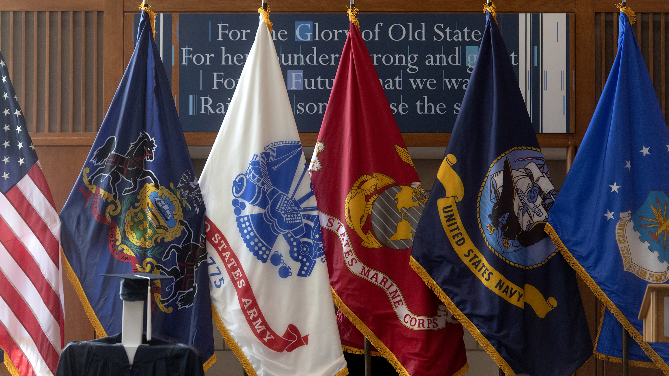 Flags from the U.S. and the service academies are shown