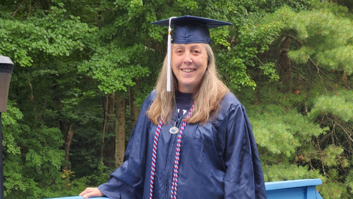 Mary Thomas wears a graduation gown and military honor cords