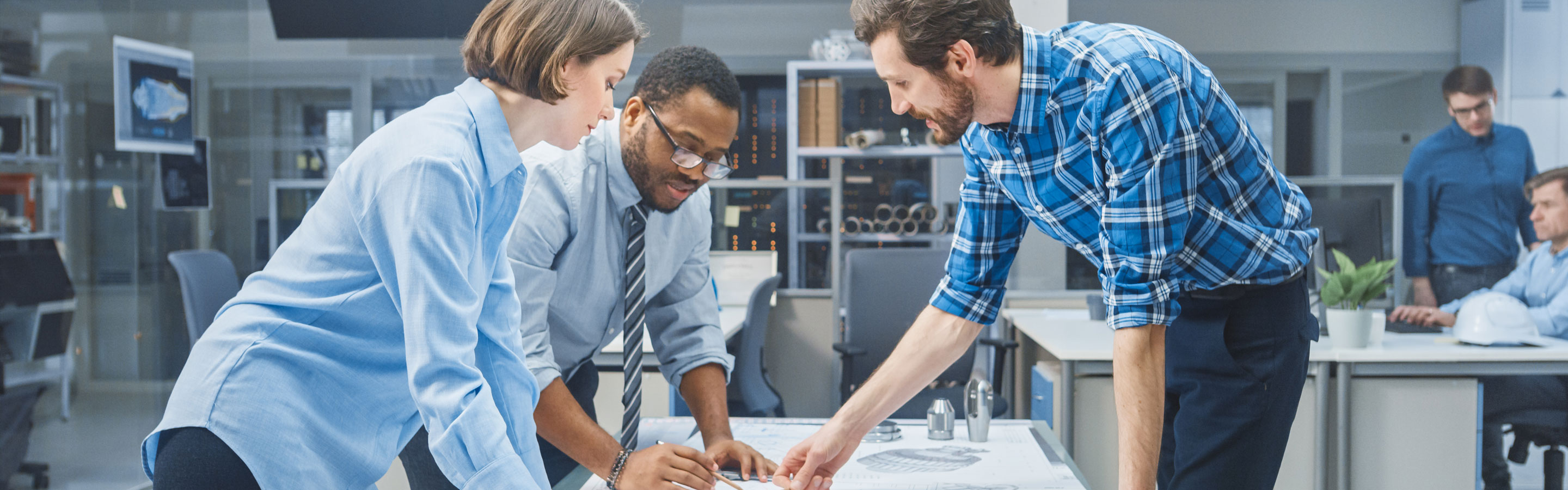 Engineers standing around a table