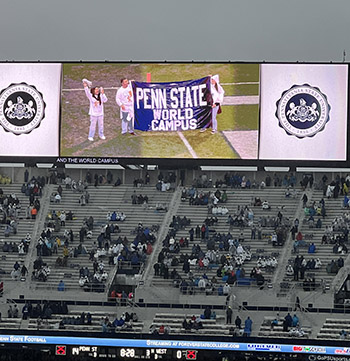 The Penn State World Campus banner and two students were shown on the electronic scoreboard at Beaver Stadium. 