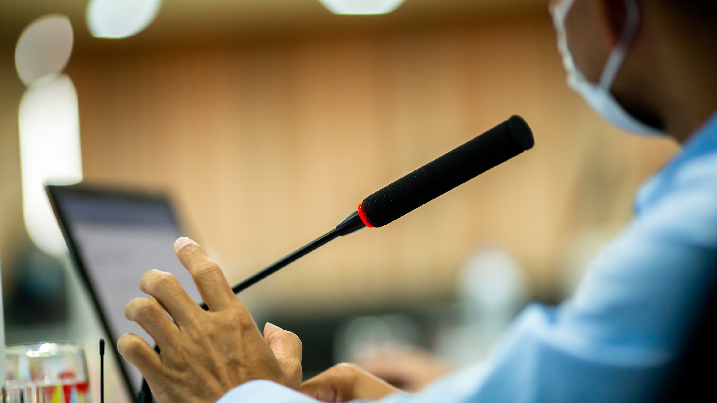 Person speaking into a microphone
