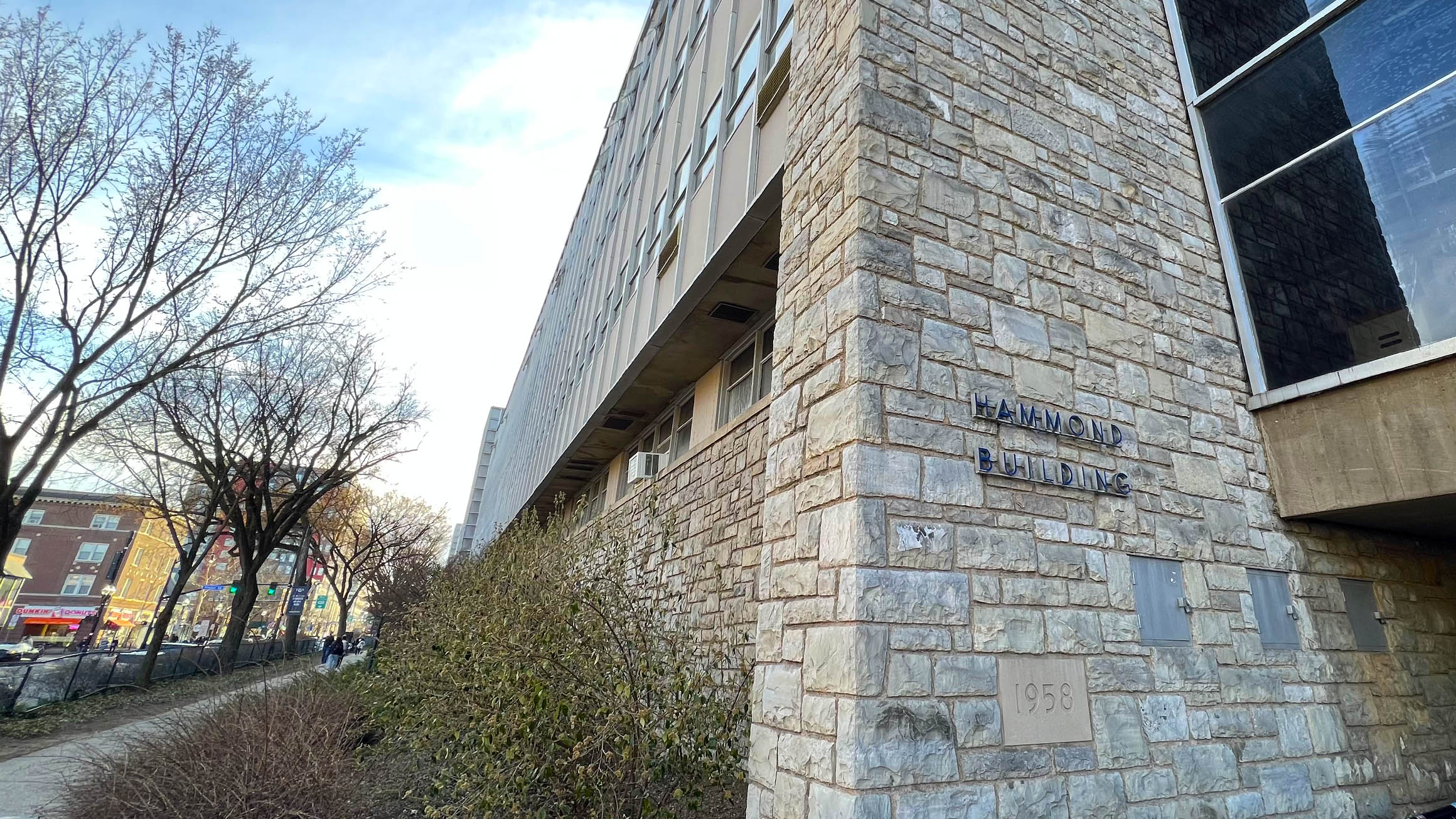 The sign for the Hammond Building at Penn State is shown on a stone wall