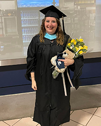 Brianne Gridley poses in graduate commencement regalia.