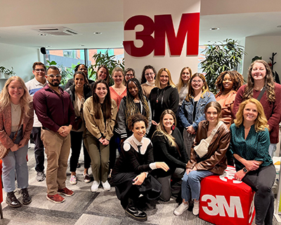 A group of people pose in an office space.