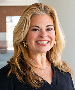 A headshot of Jill Wood smiling