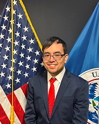 David Nguyen is seen with a U.S. flag and another flag in the background