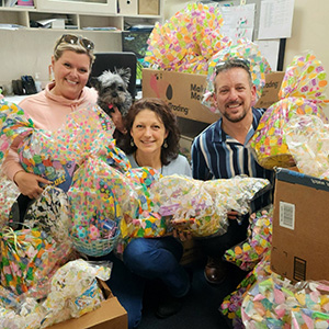 Michelle Weissmann holds gift baskets that were donations to her shelter.