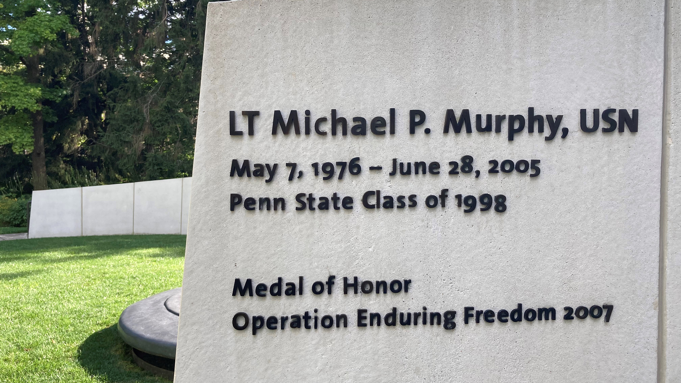 A concrete memorial honors veterans and service members.