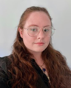 A headshot of a woman wearing glasses.