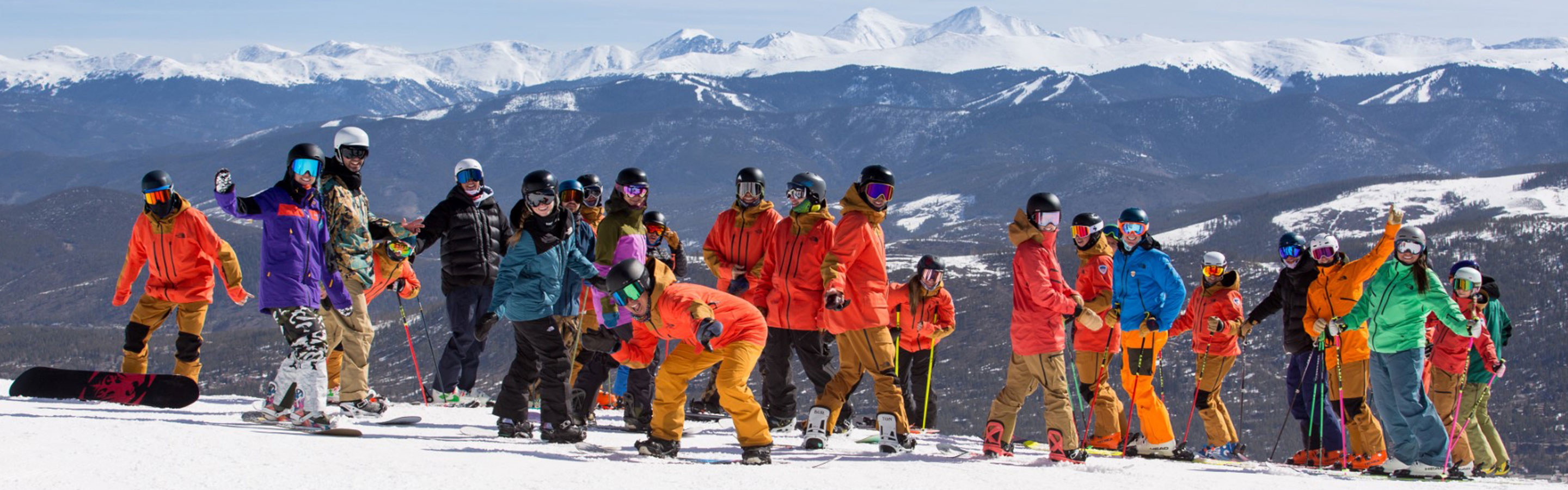 skiers and snowboarders on a snowy mountain 