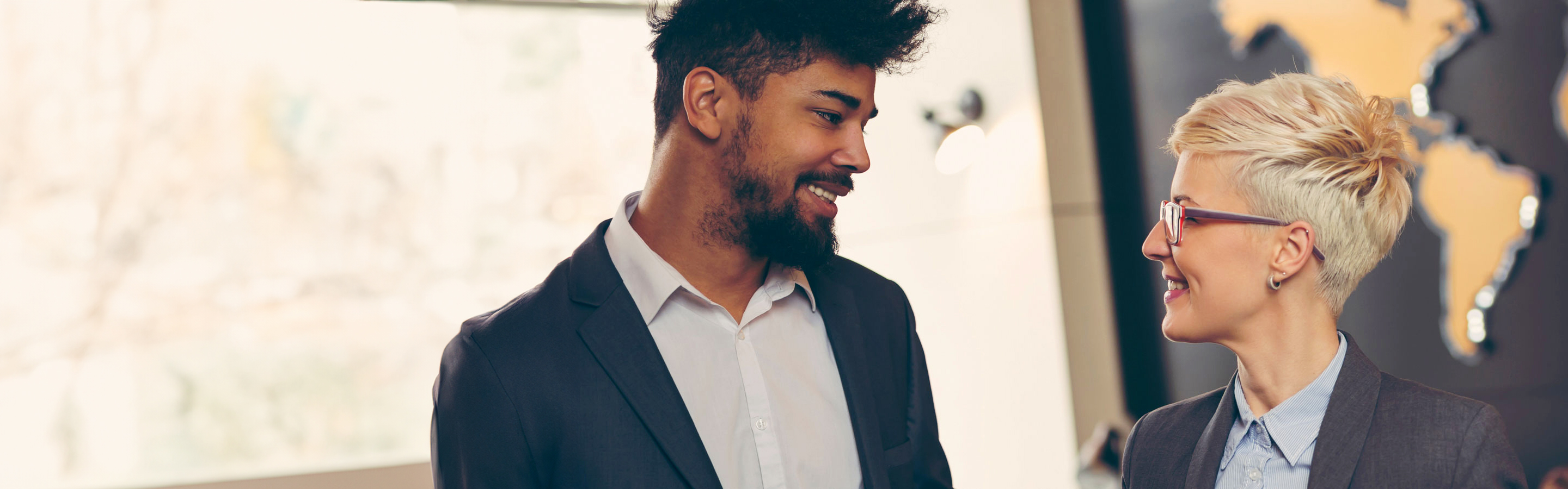 coworkers smiling at each in an office setting 