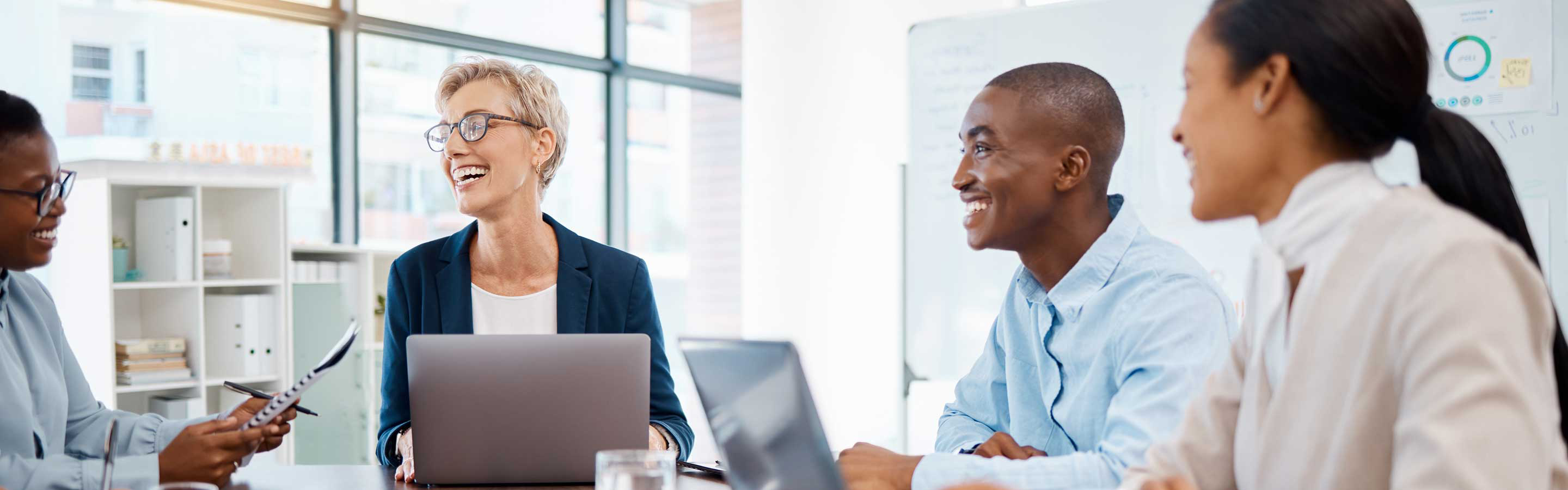 professionals smiling at each during a meeting