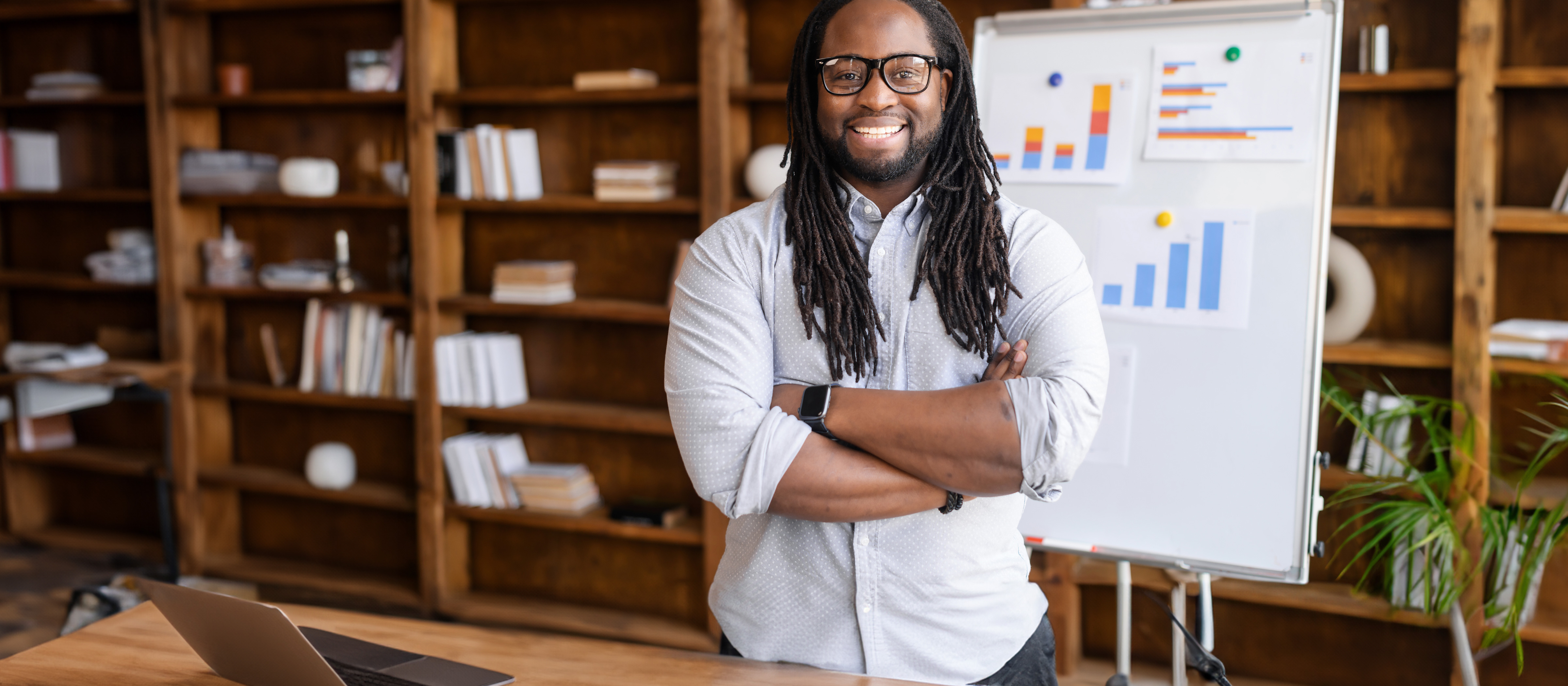 man smiling in front of a research poster