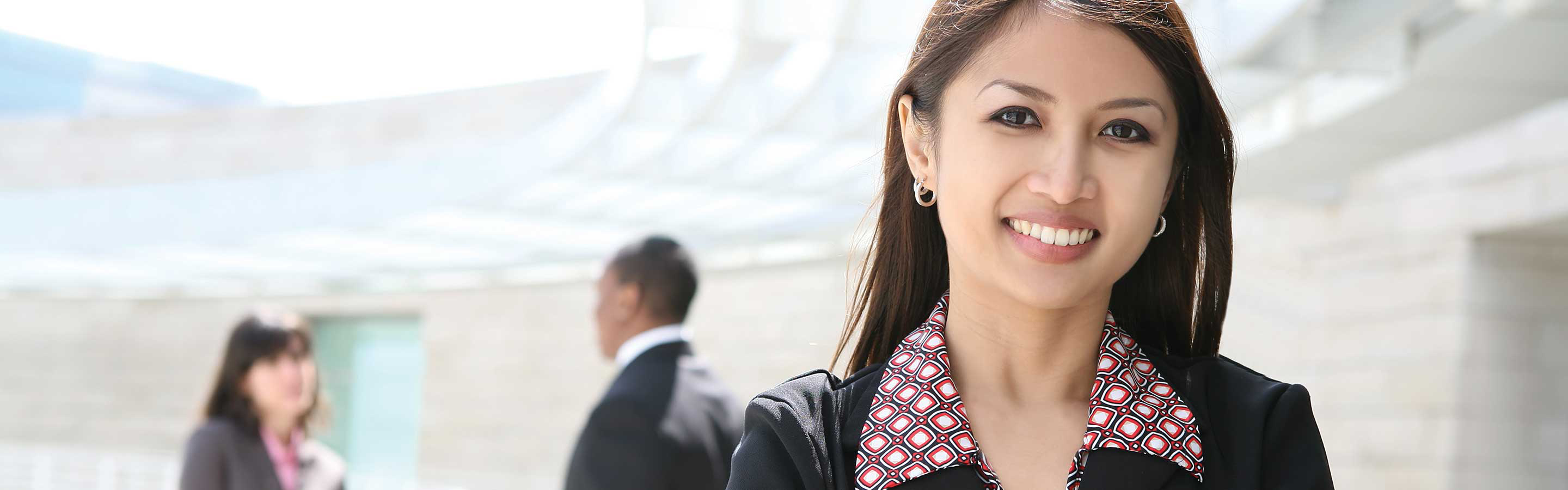 woman dressed in business attire smiling at the camera