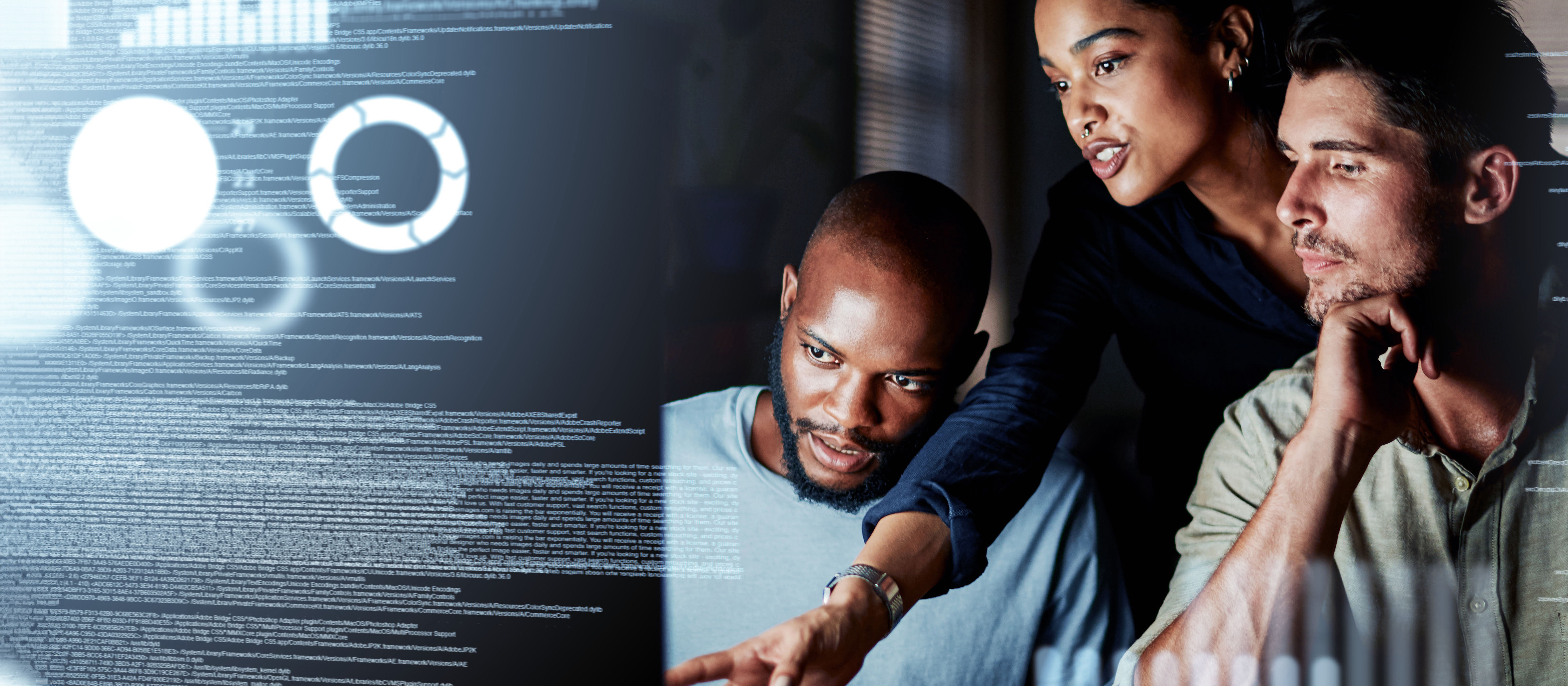 cybersecurity professionals conversing while looking at a computer screen