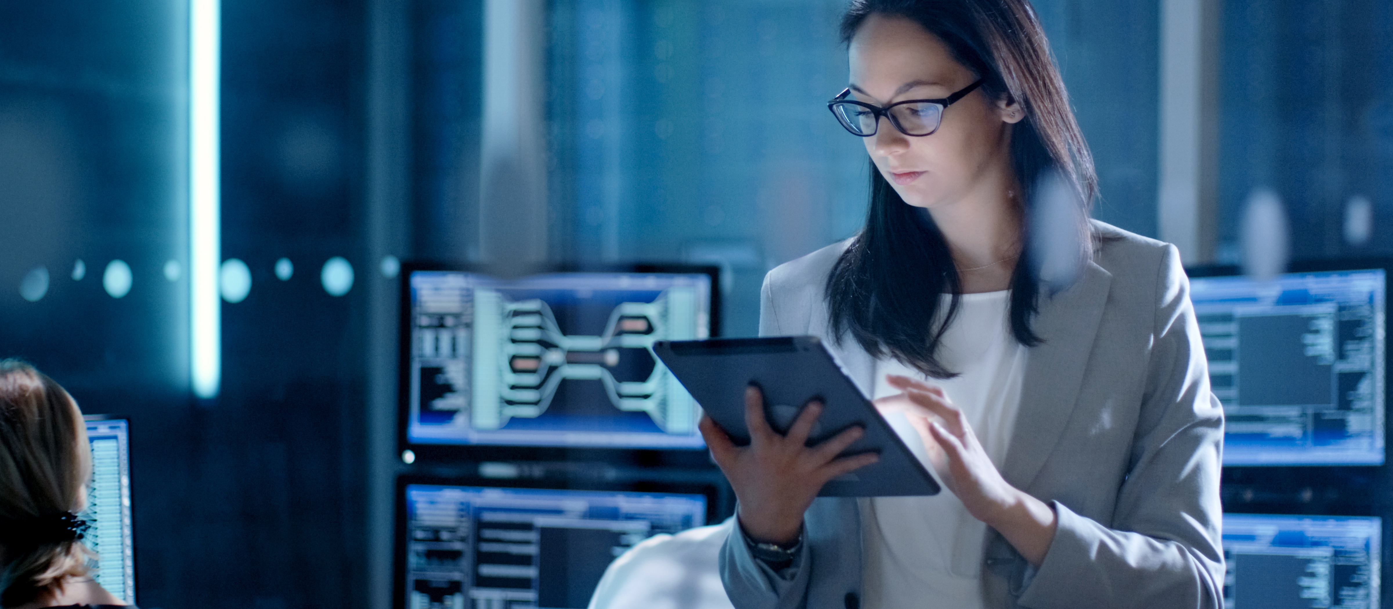 cyber security professional looking at a tablet