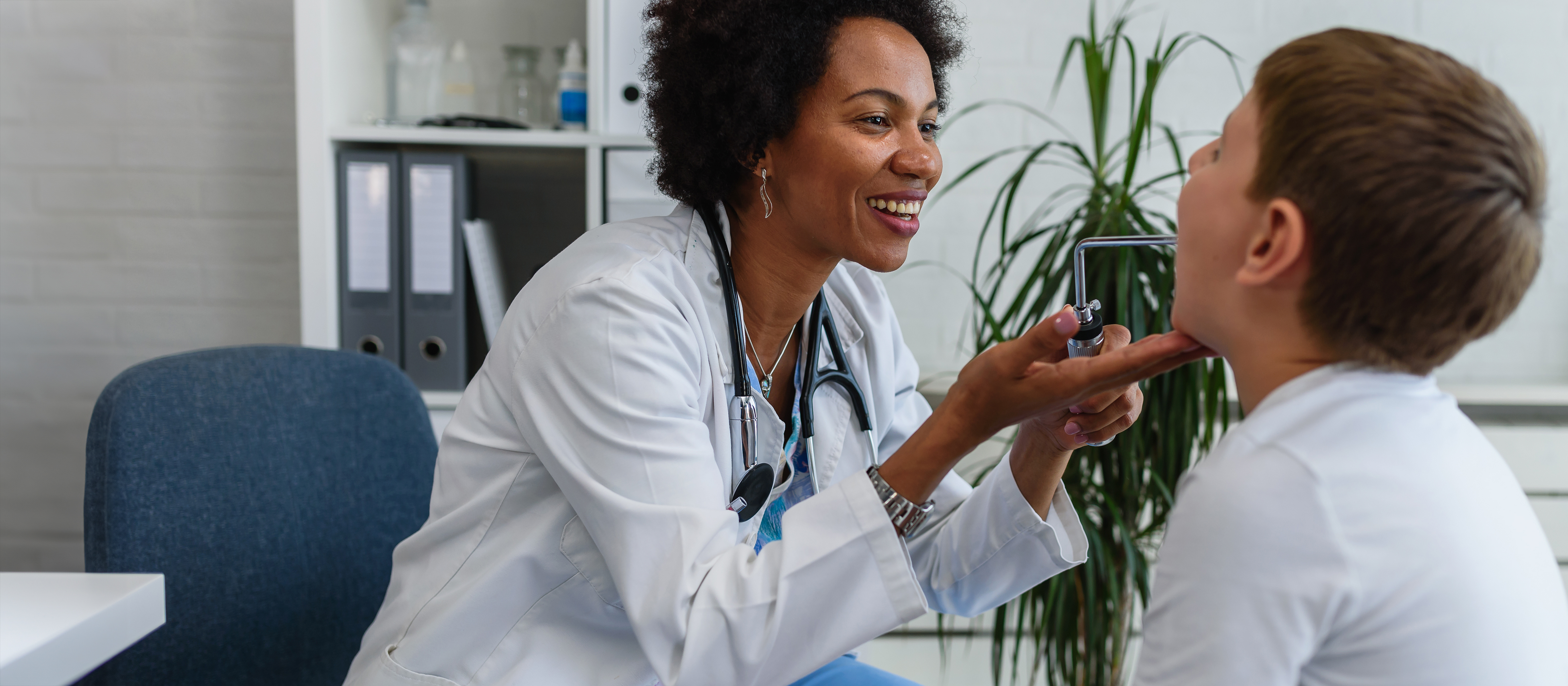 doctor smiling while examining a child 