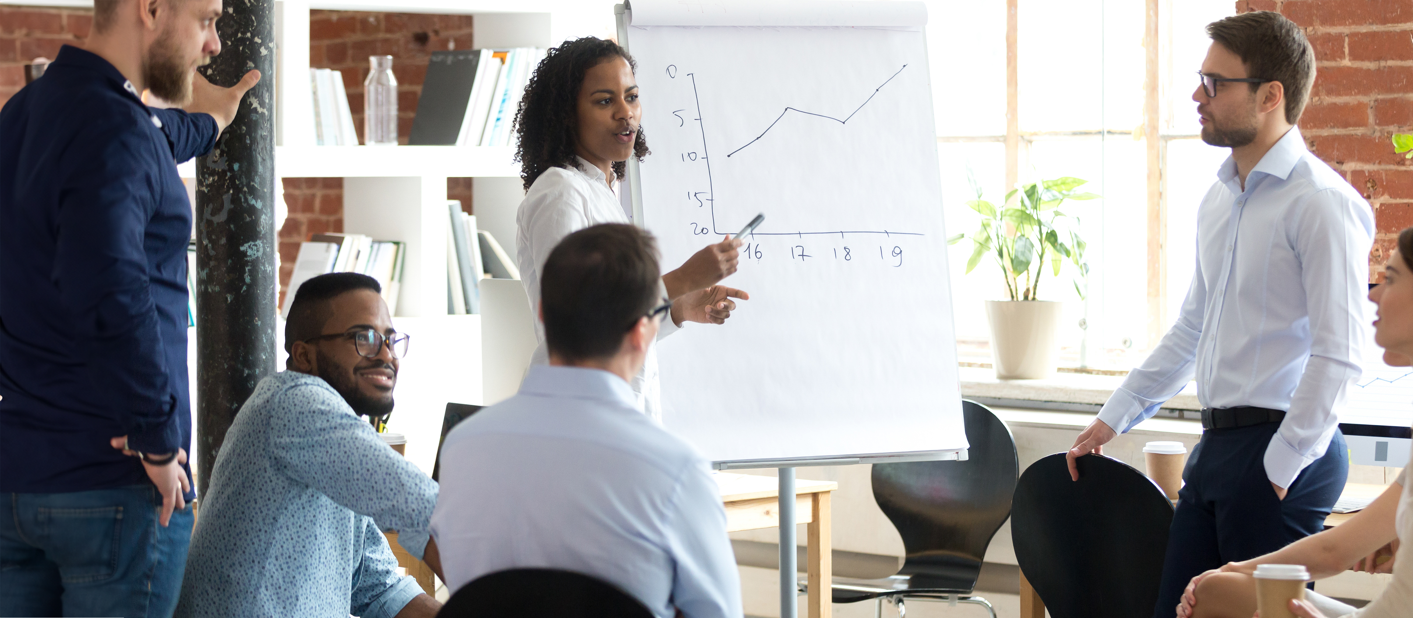 project manager presenting a graph to a group of people