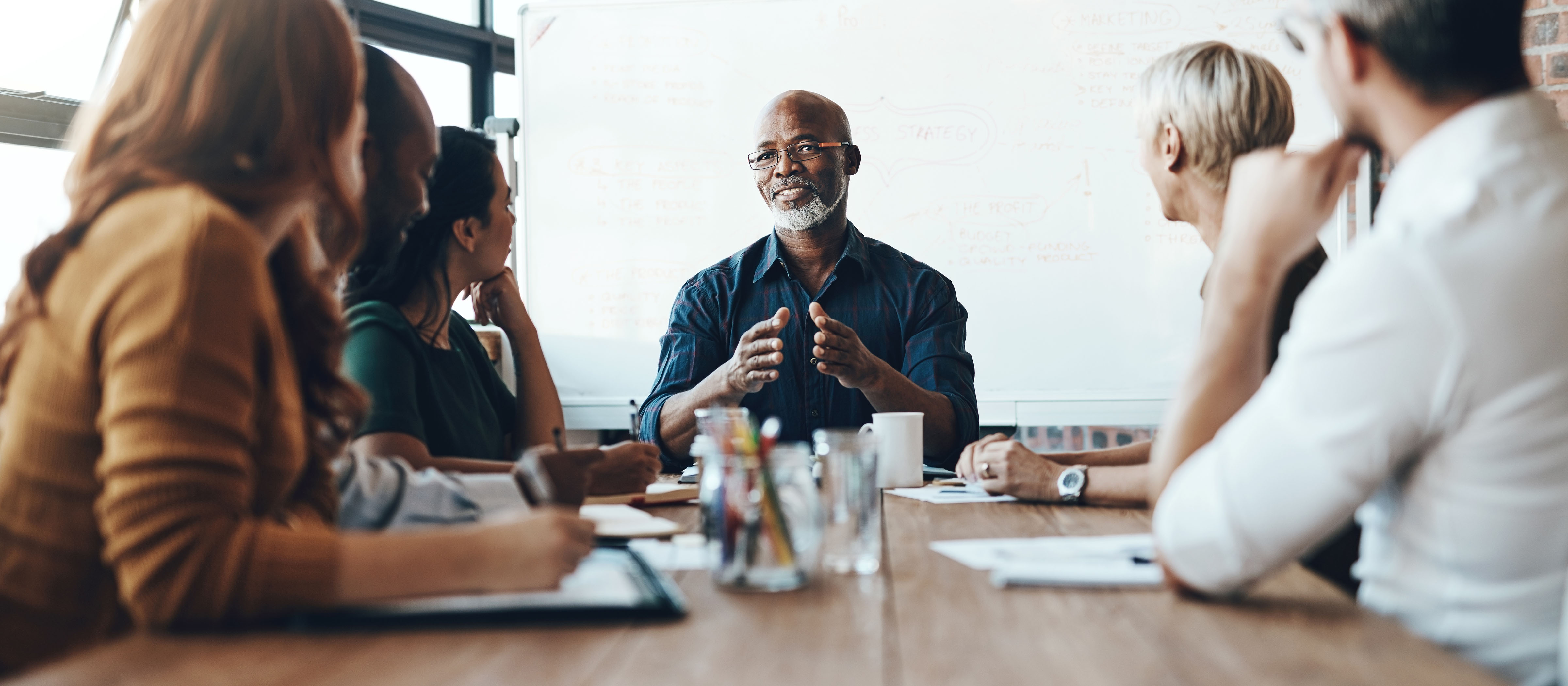 man speaking during a meeting at a table 